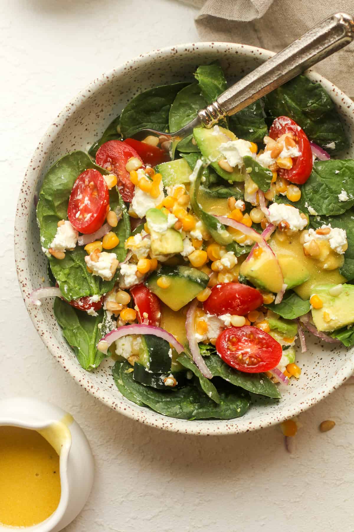 A serving of goat cheese spinach salad.