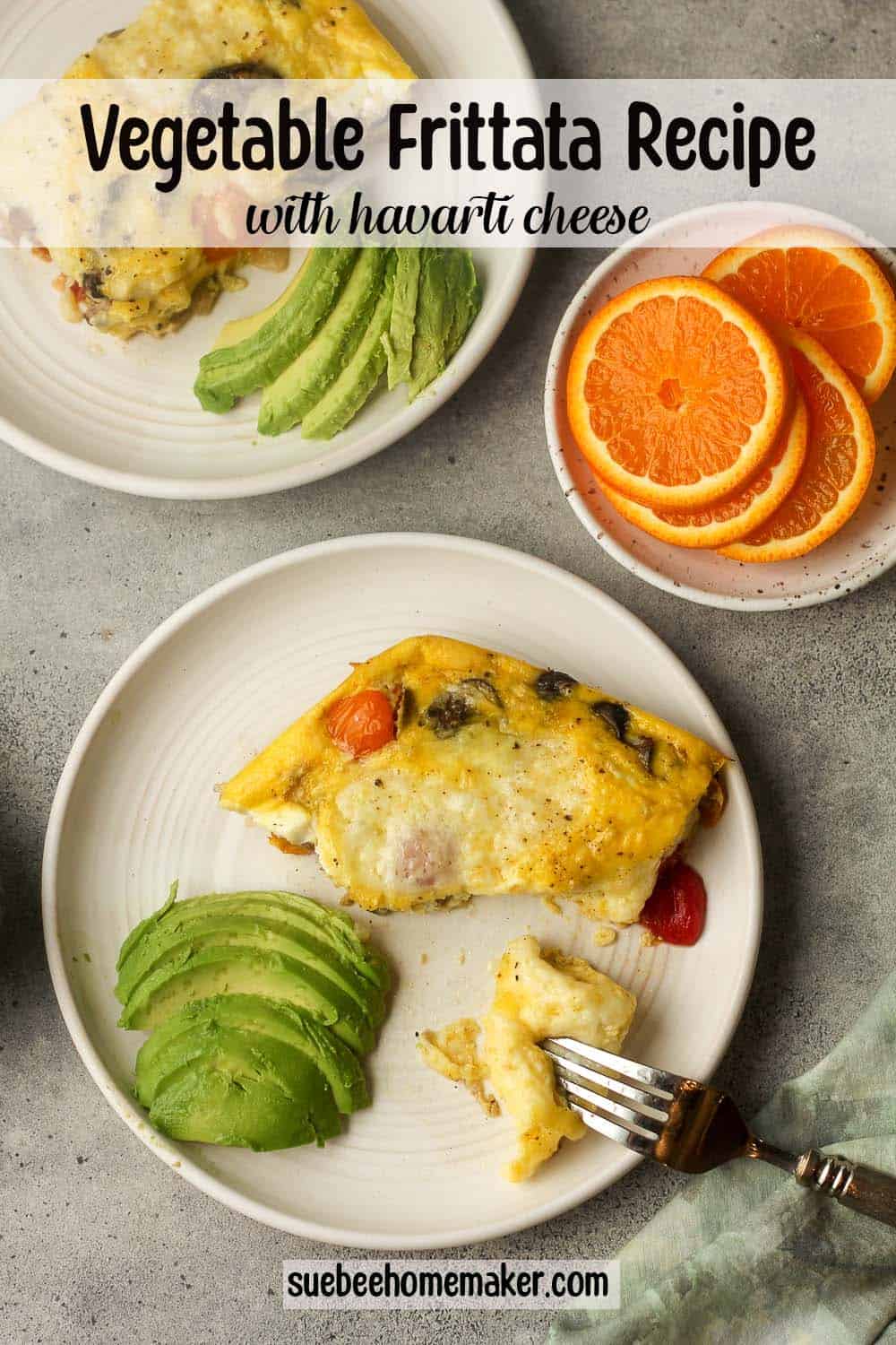 Two plates of veggie frittata with avocado slices.
