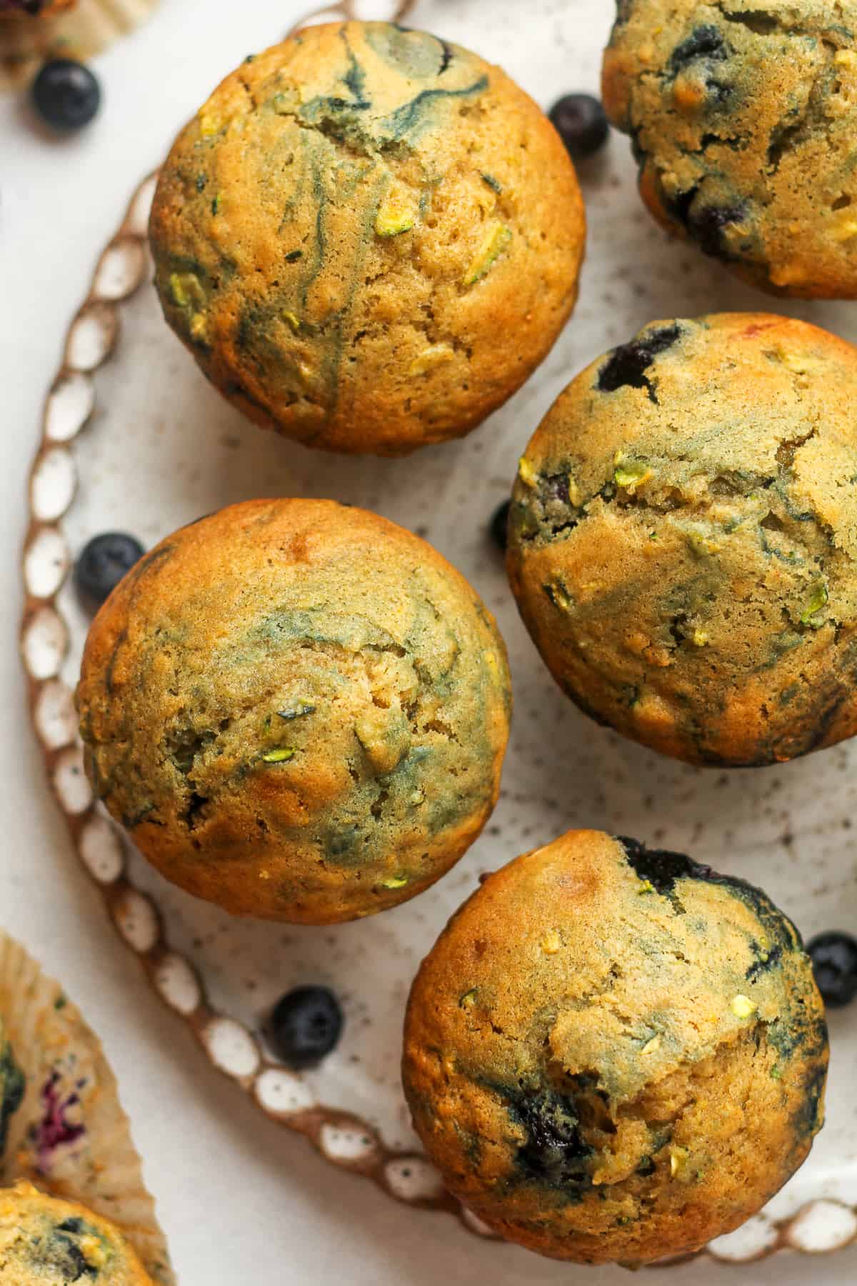 A plate of several blueberry zucchini muffins.