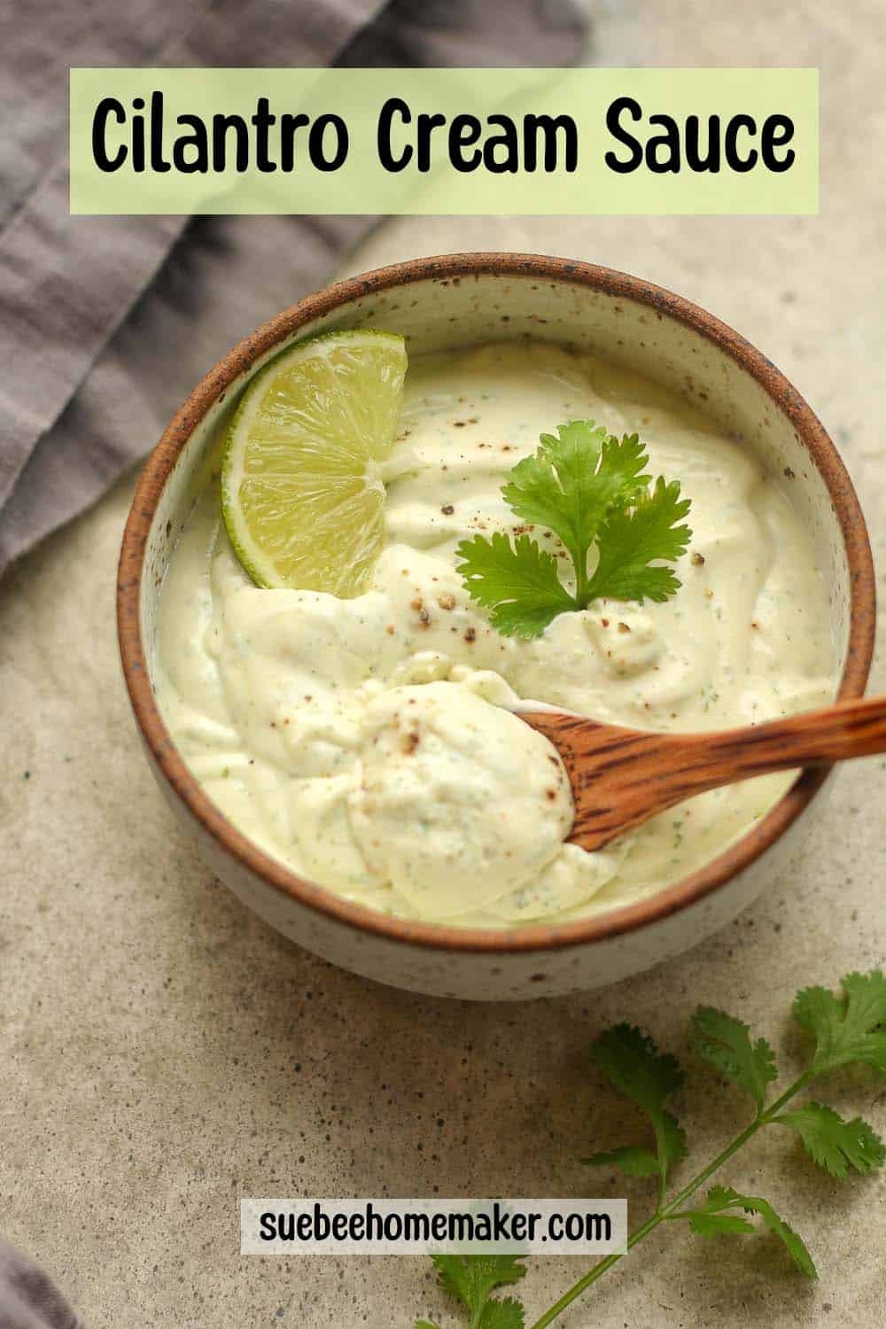 A bowl of cilantro lime dressing with a spoon inside the bowl.