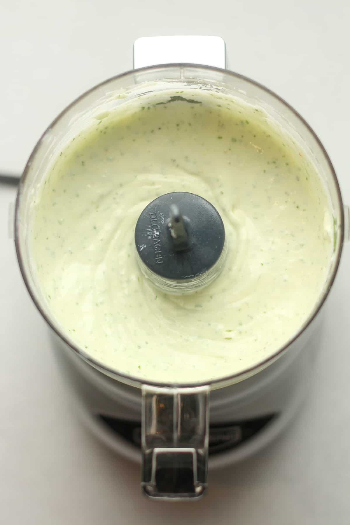 A small food processor of the blended dressing.