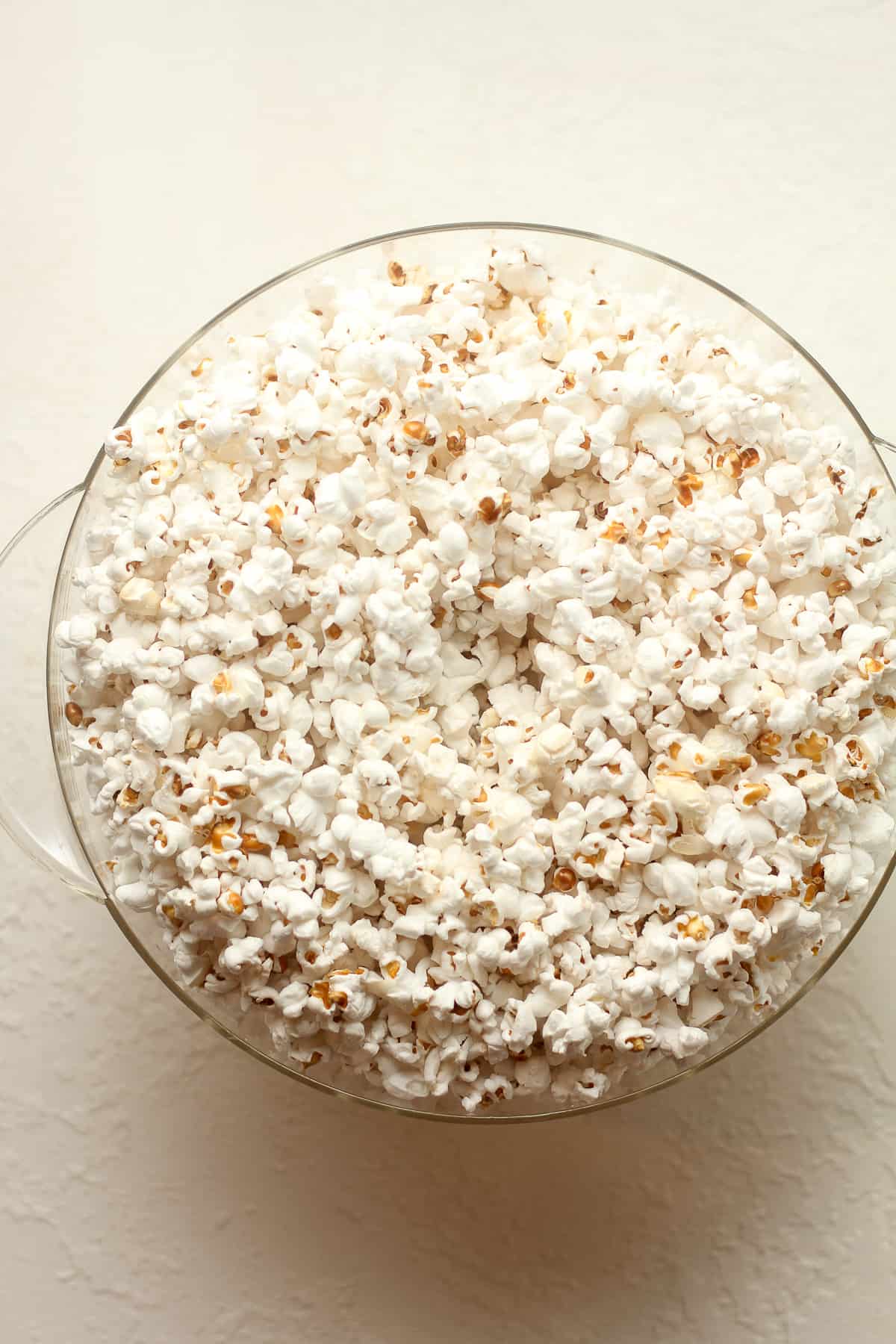 A popcorn popper lid of popped corn.