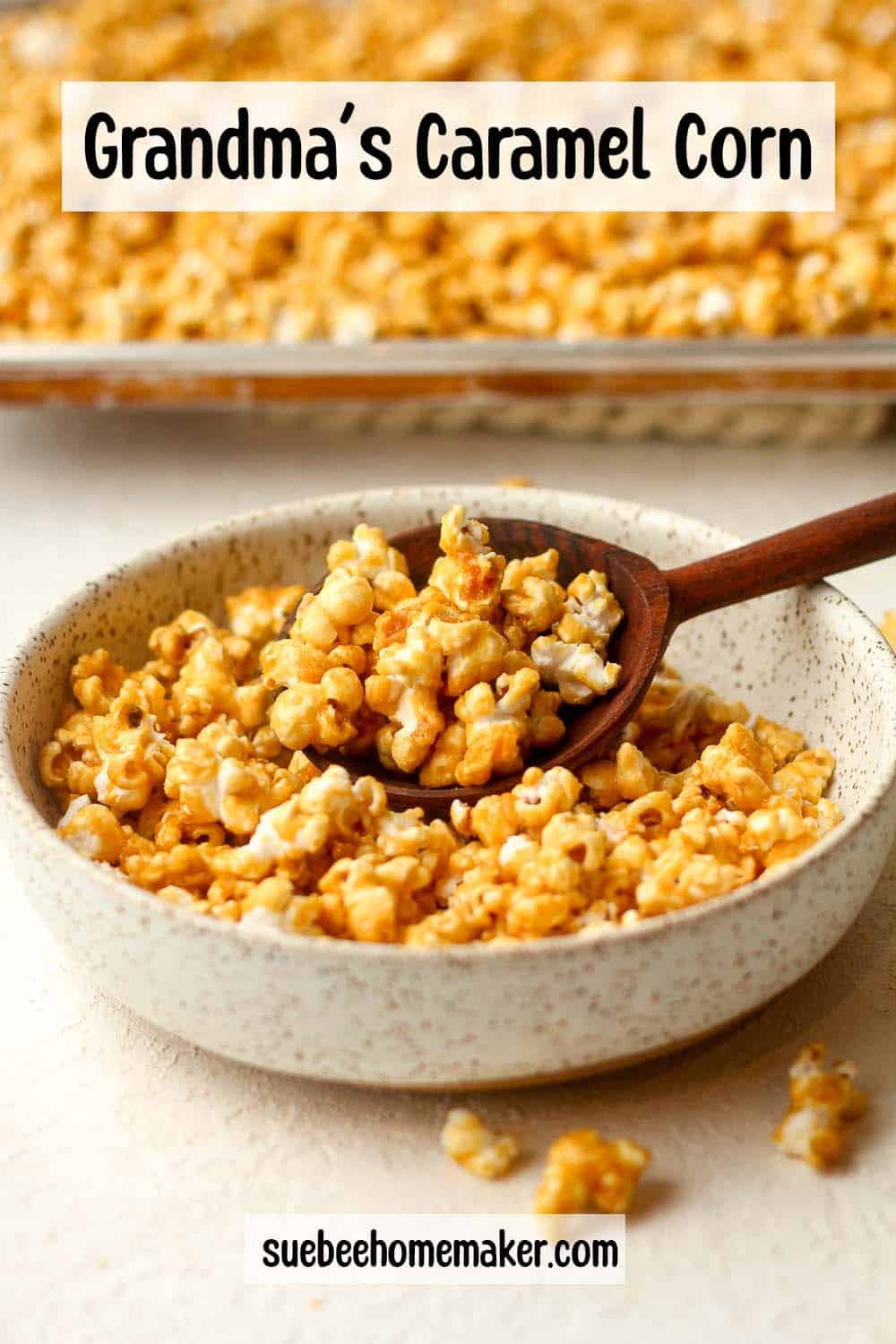 Side view of a bowl of Grandma's caramel corn in front of a pan.