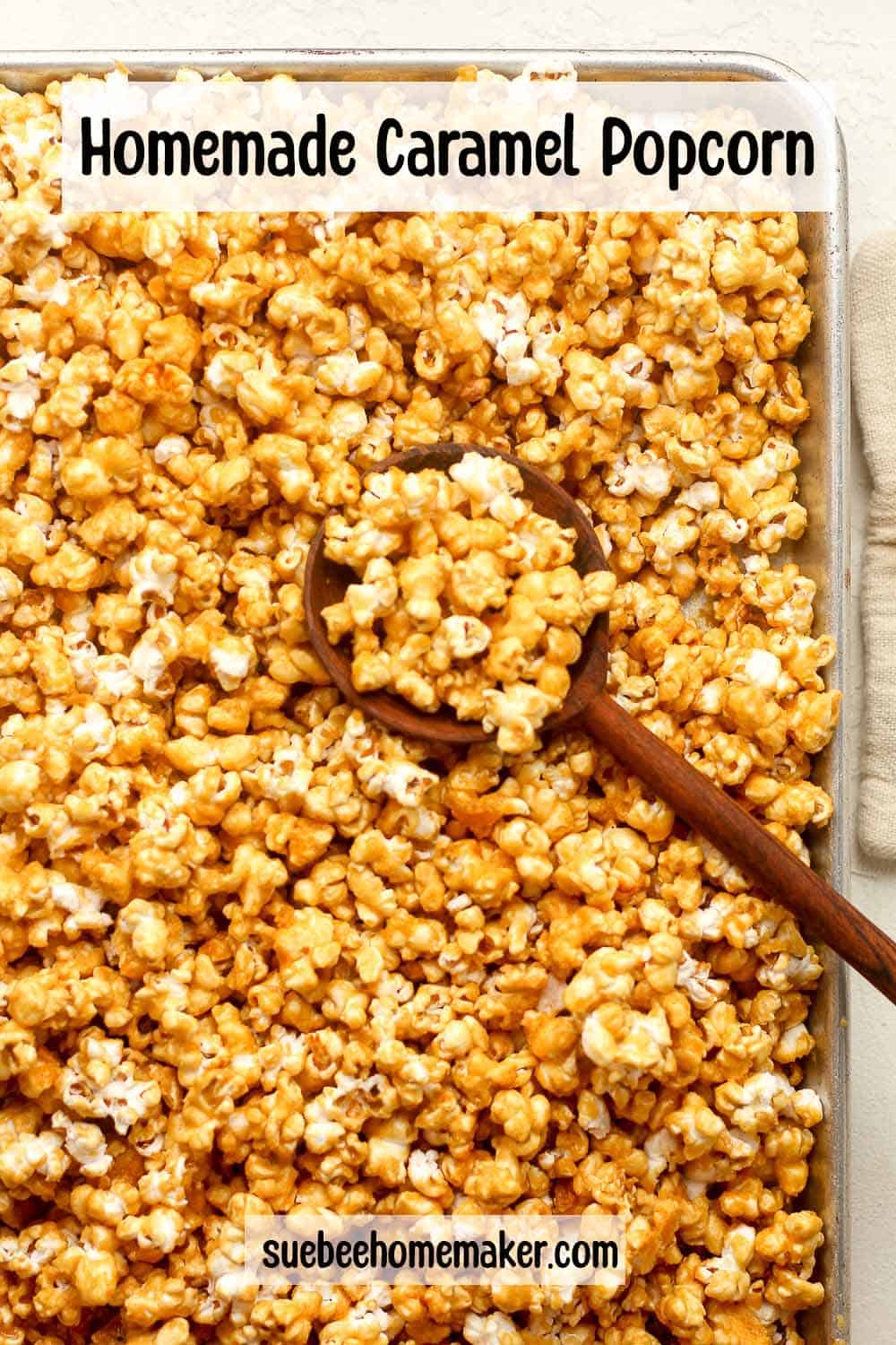 Overhead view of a pan of homemade caramel popcorn with a spoon.