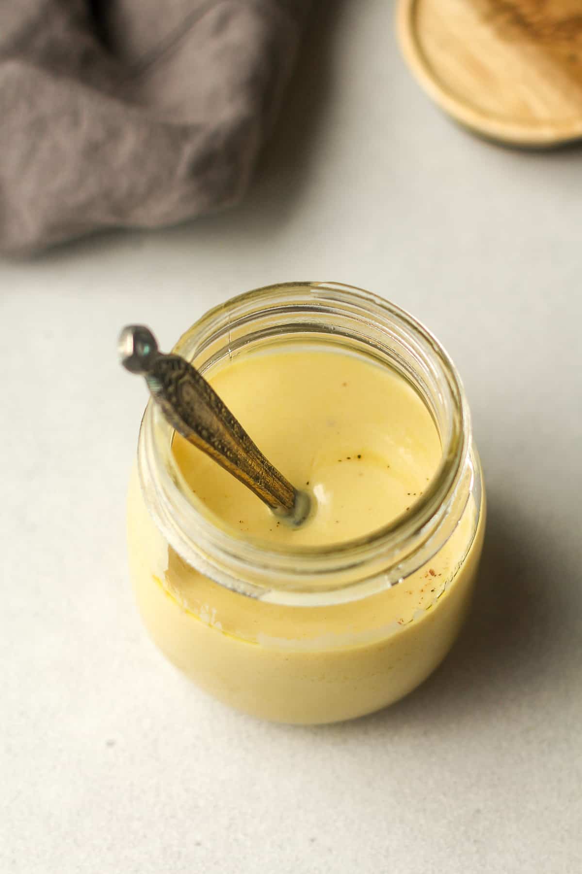 Overhead view of a mason jar with a teaspoon inside it.