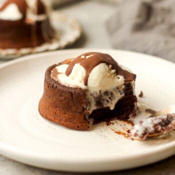 Side view of a mini lava cake with ice cream on top.