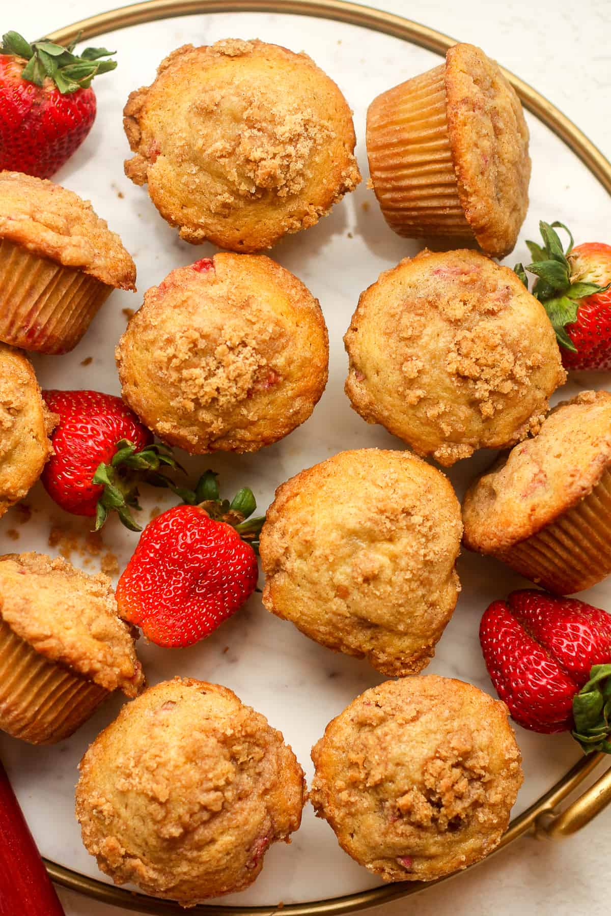 Overhead view of strawberry rhubarb muffins with streusel.
