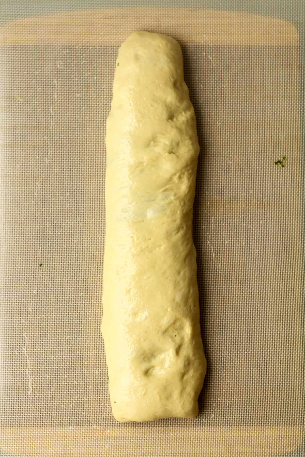 The long roll of bread dough.