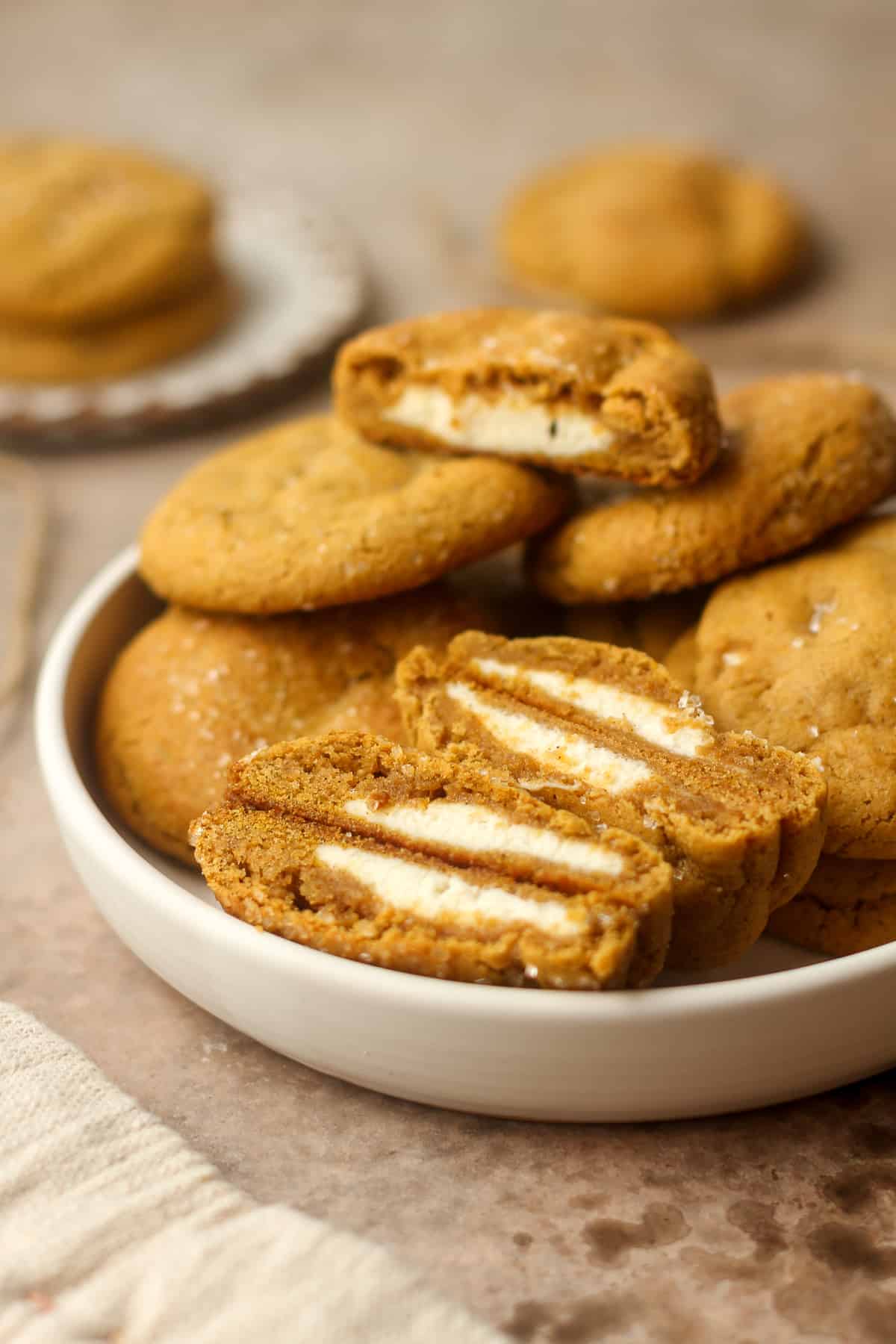 Side view of a bowl of stuffed pumpkin cookies.