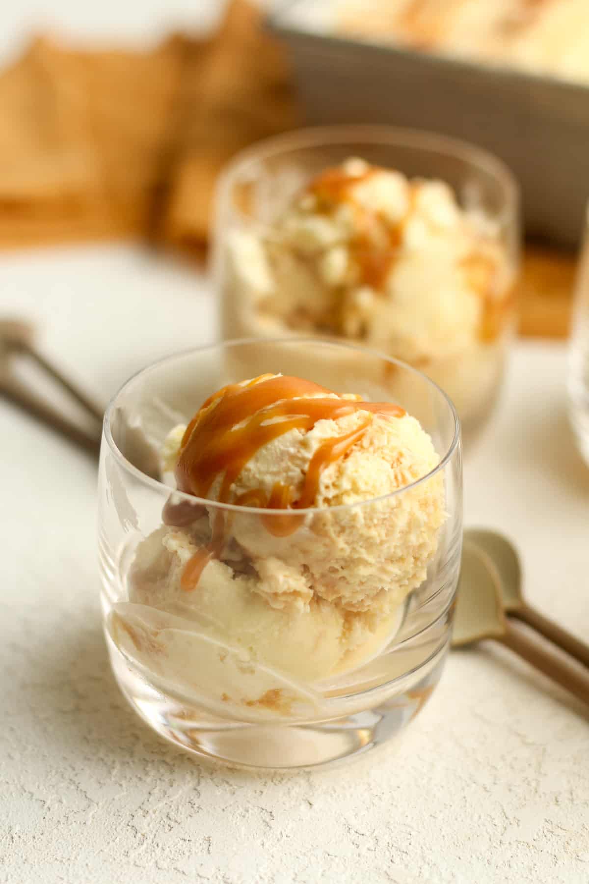 Side view of two glasses of caramel swirl ice cream.