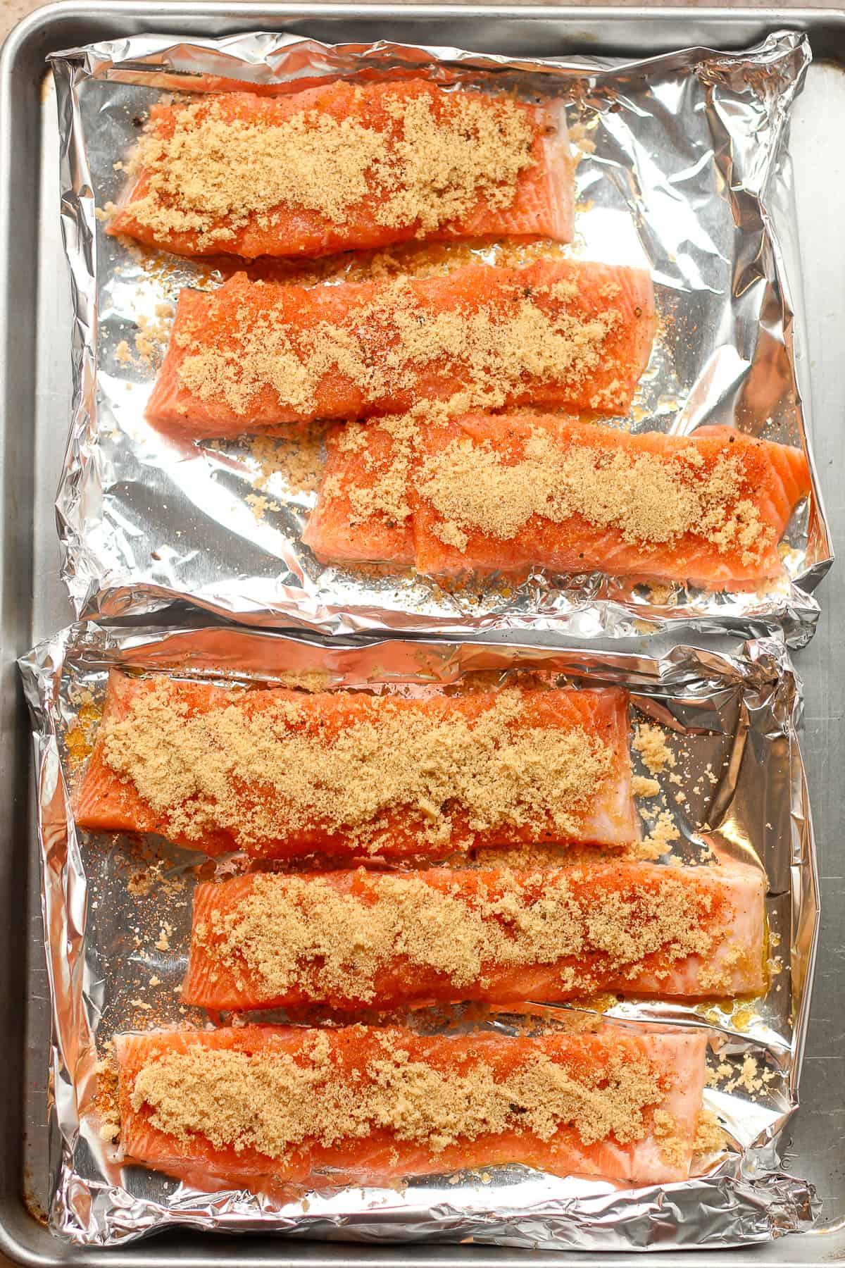 Six pieces of salmon topped with seasoning and brown sugar.