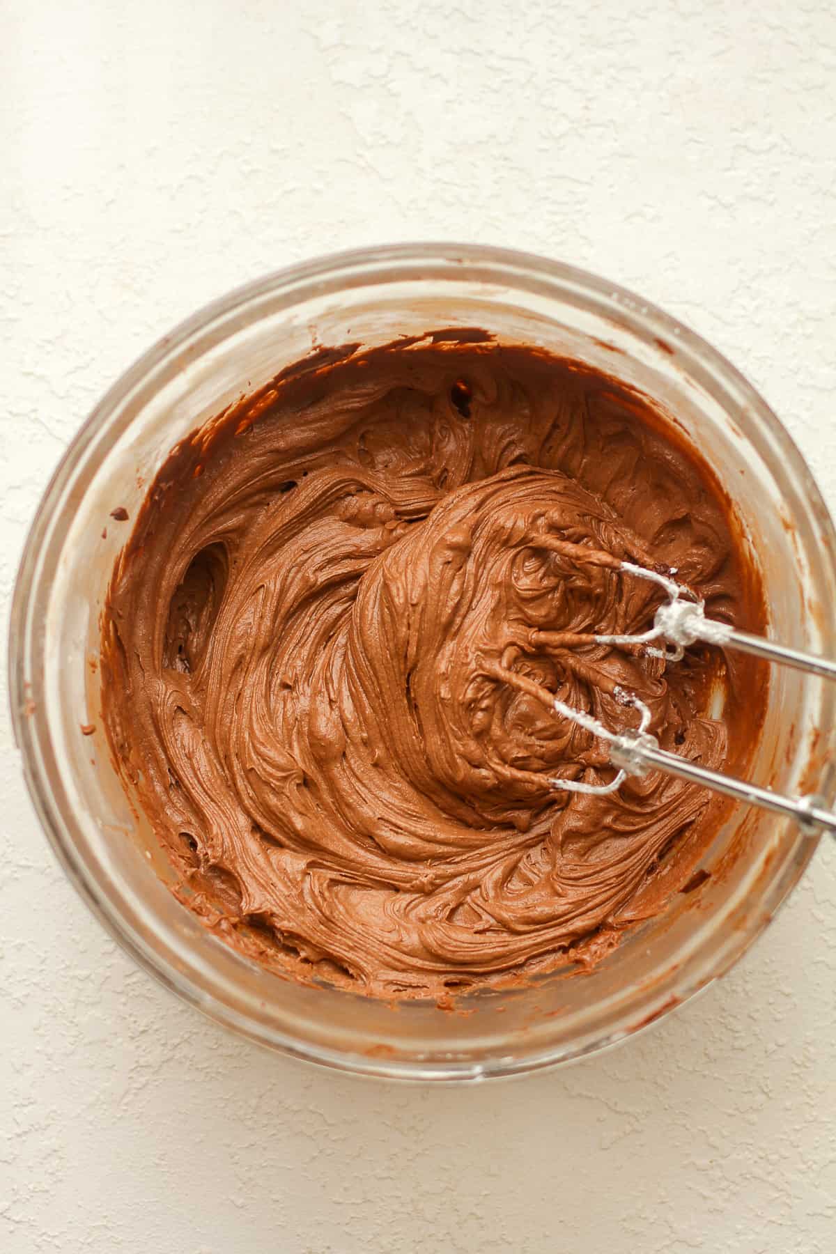 A bowl of chocolate frosting.