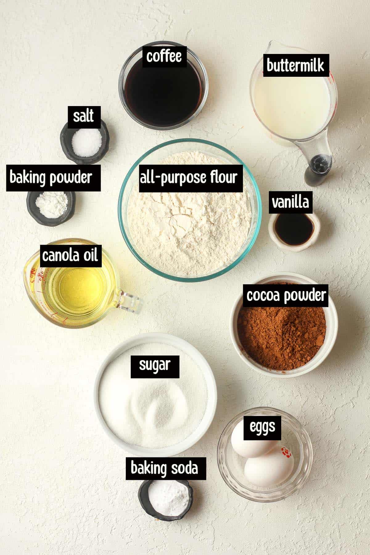 The cake ingredients in small bowls, labeled.