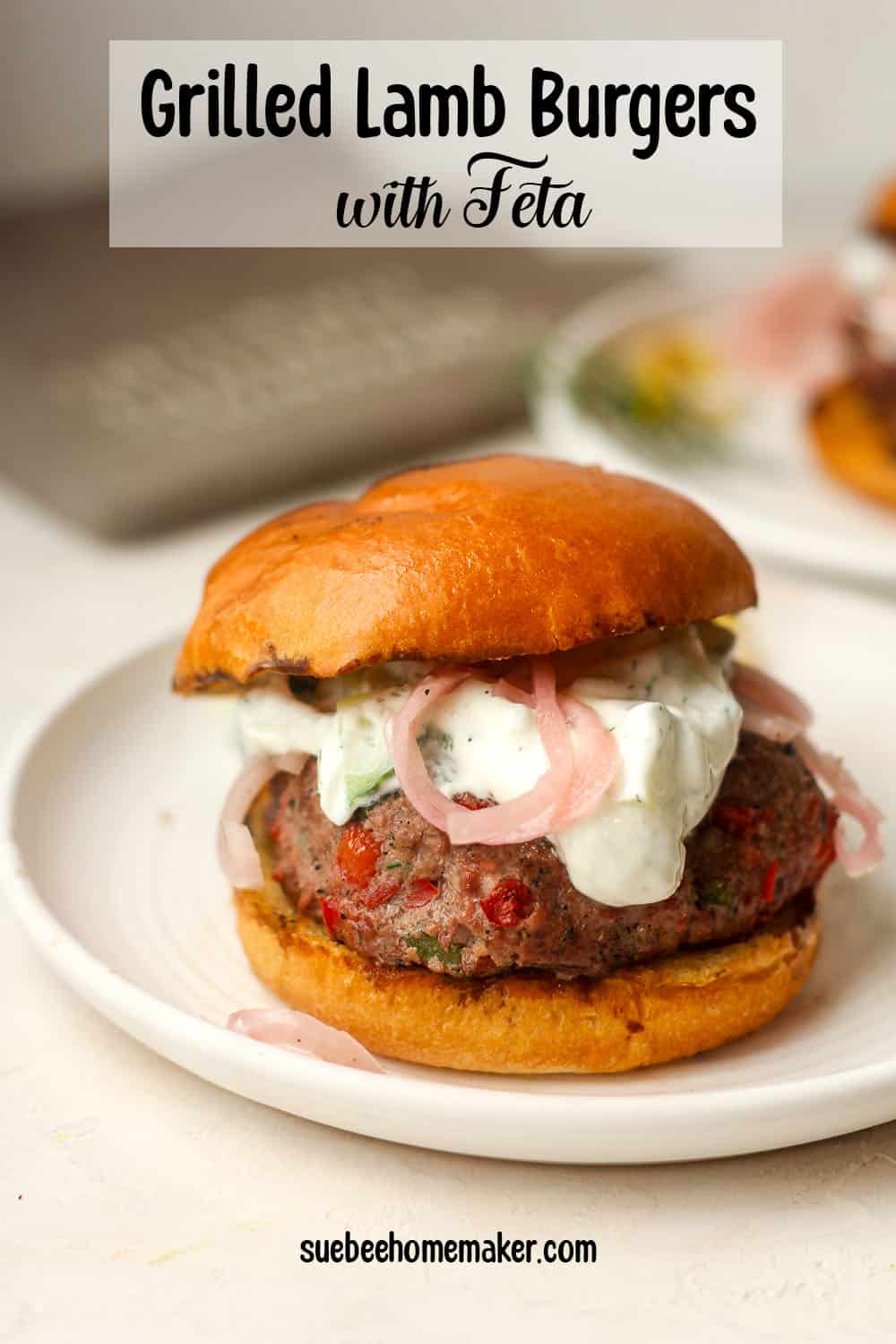 A big lamb burger with feta in a bun with toppings.