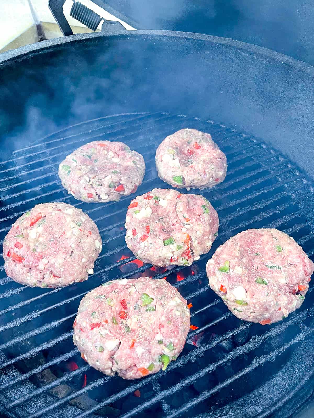 A grill with some feta burgers.