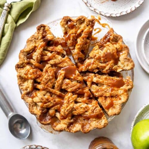 A caramel apple pie with a slice beside it.
