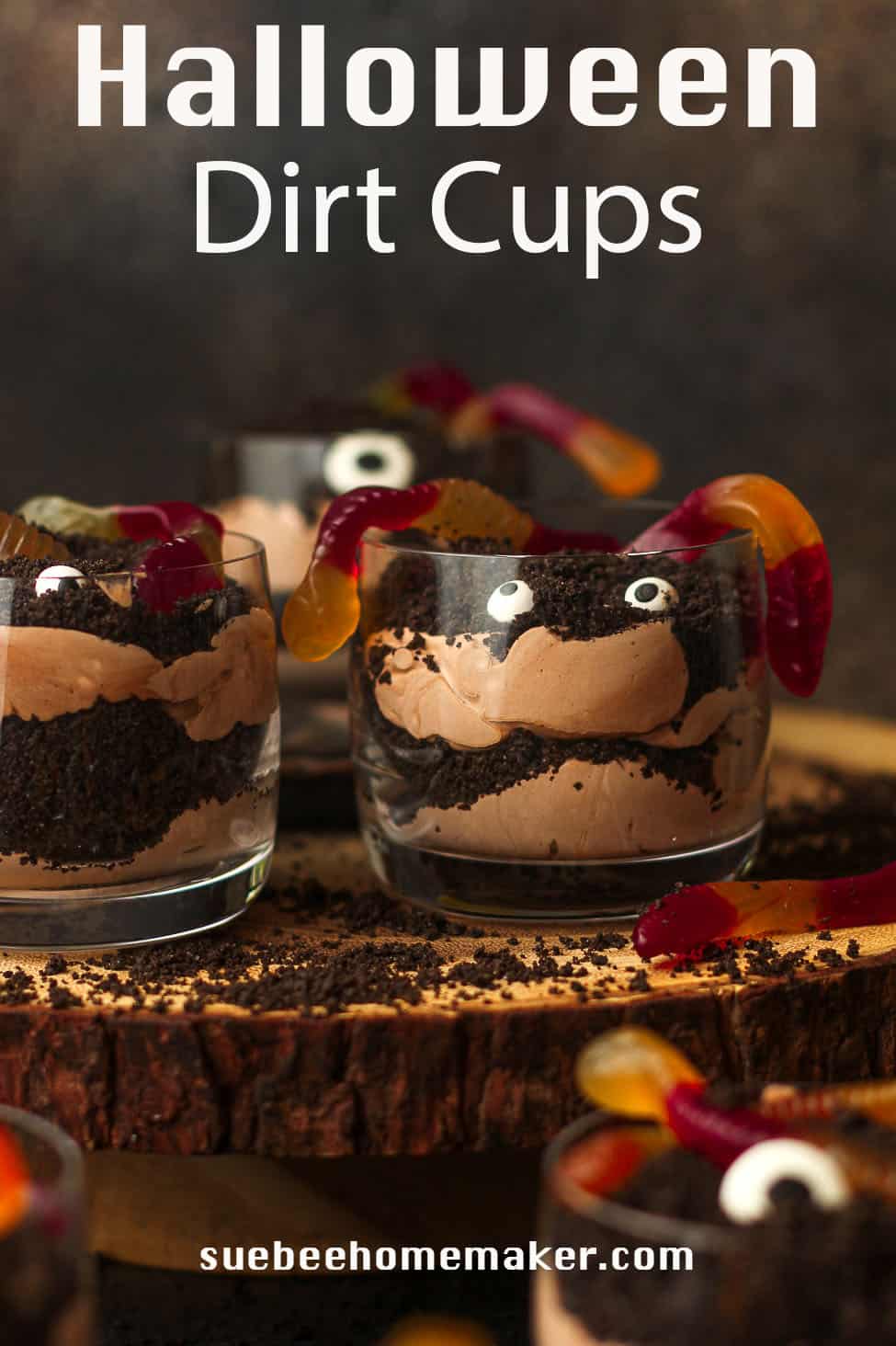 Side view of several Halloween dirt cups with spooky eyes.