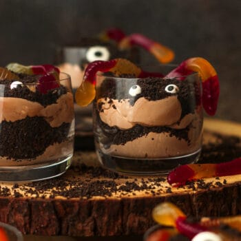 Side view of some Halloween dirt cups with gummy worms.