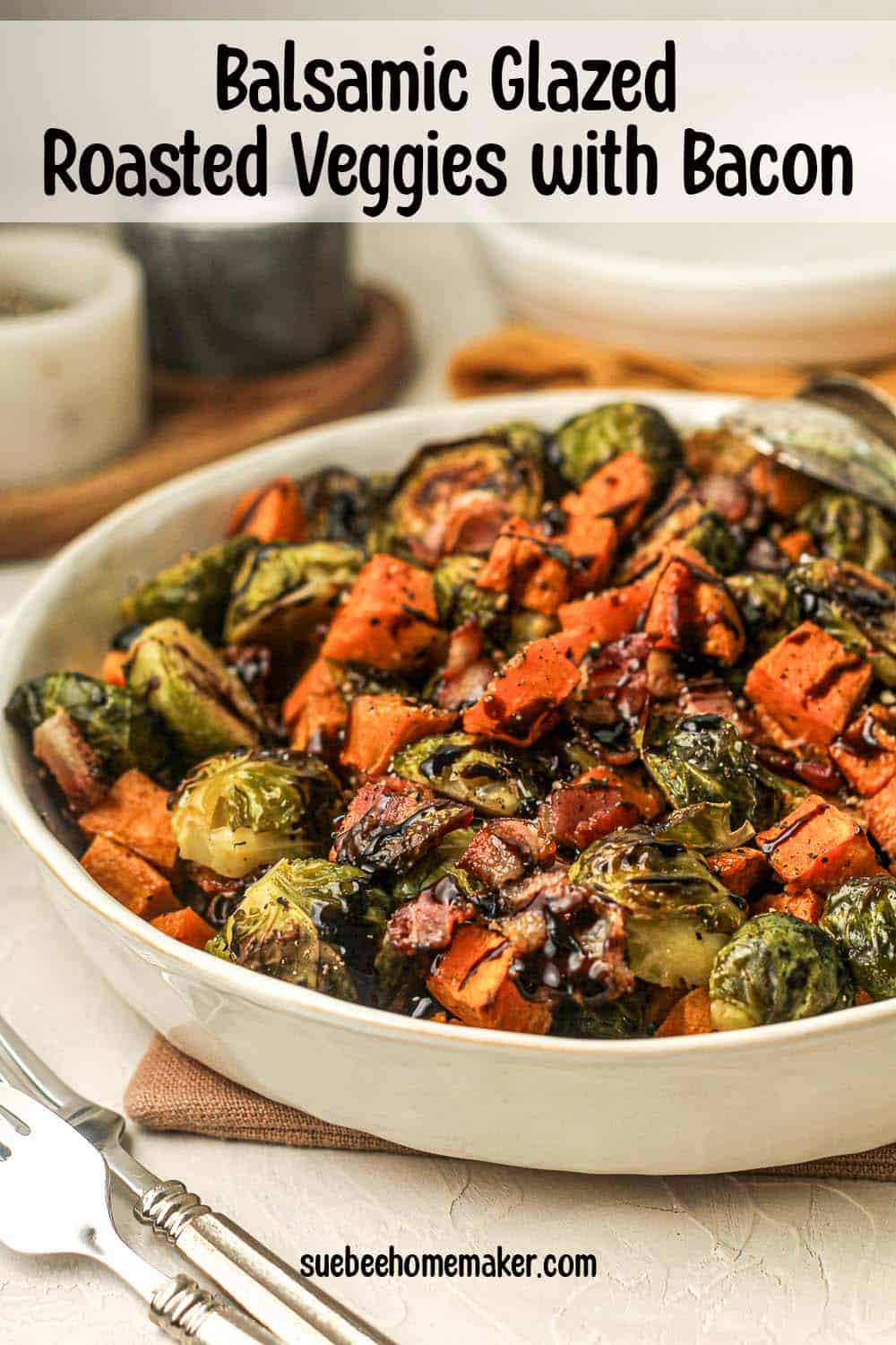 Side view of a large serving bowl of balsamic glazed roasted veggies with bacon.