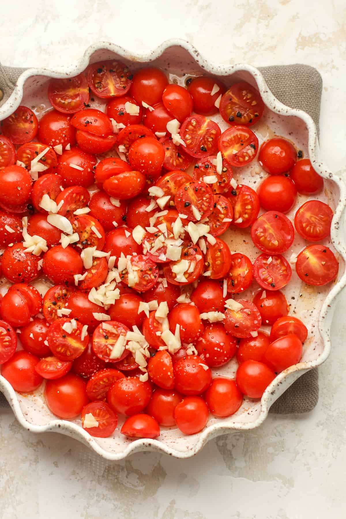 A dish of roasted tomatoes and garlic on top.