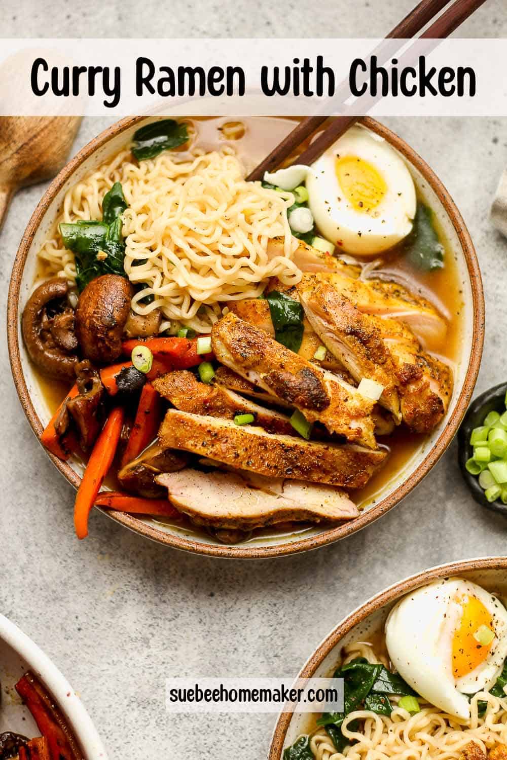 A bowl of curry ramen with chicken and veggies.