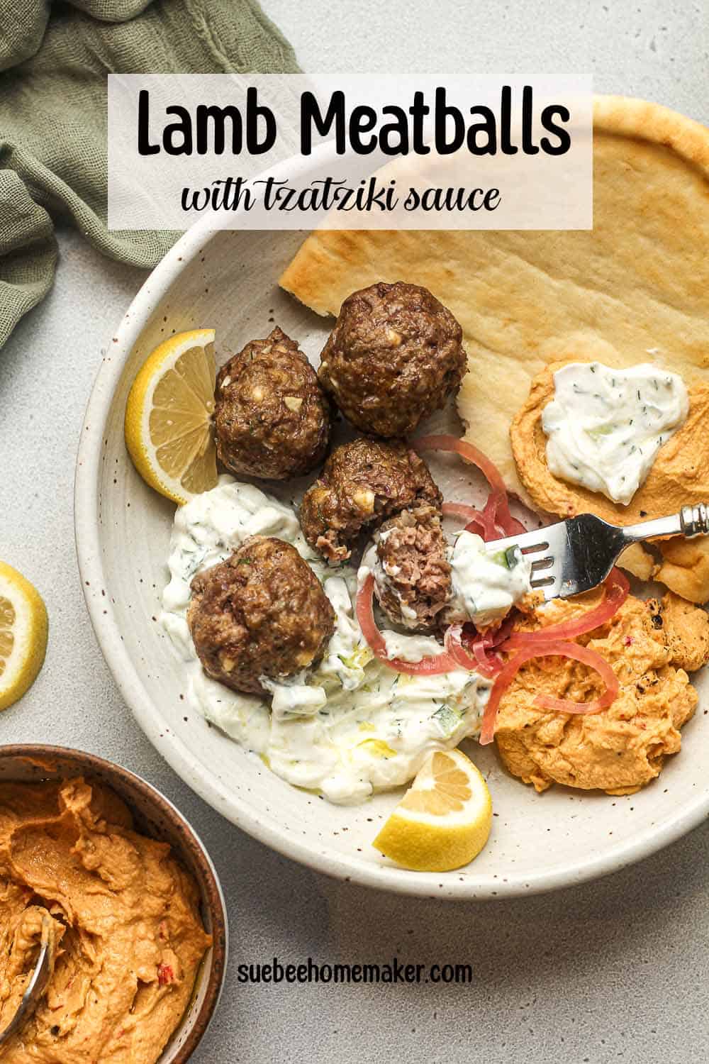 Overhead view of a bowl of Greek meatballs with tzatziki and hummus.
