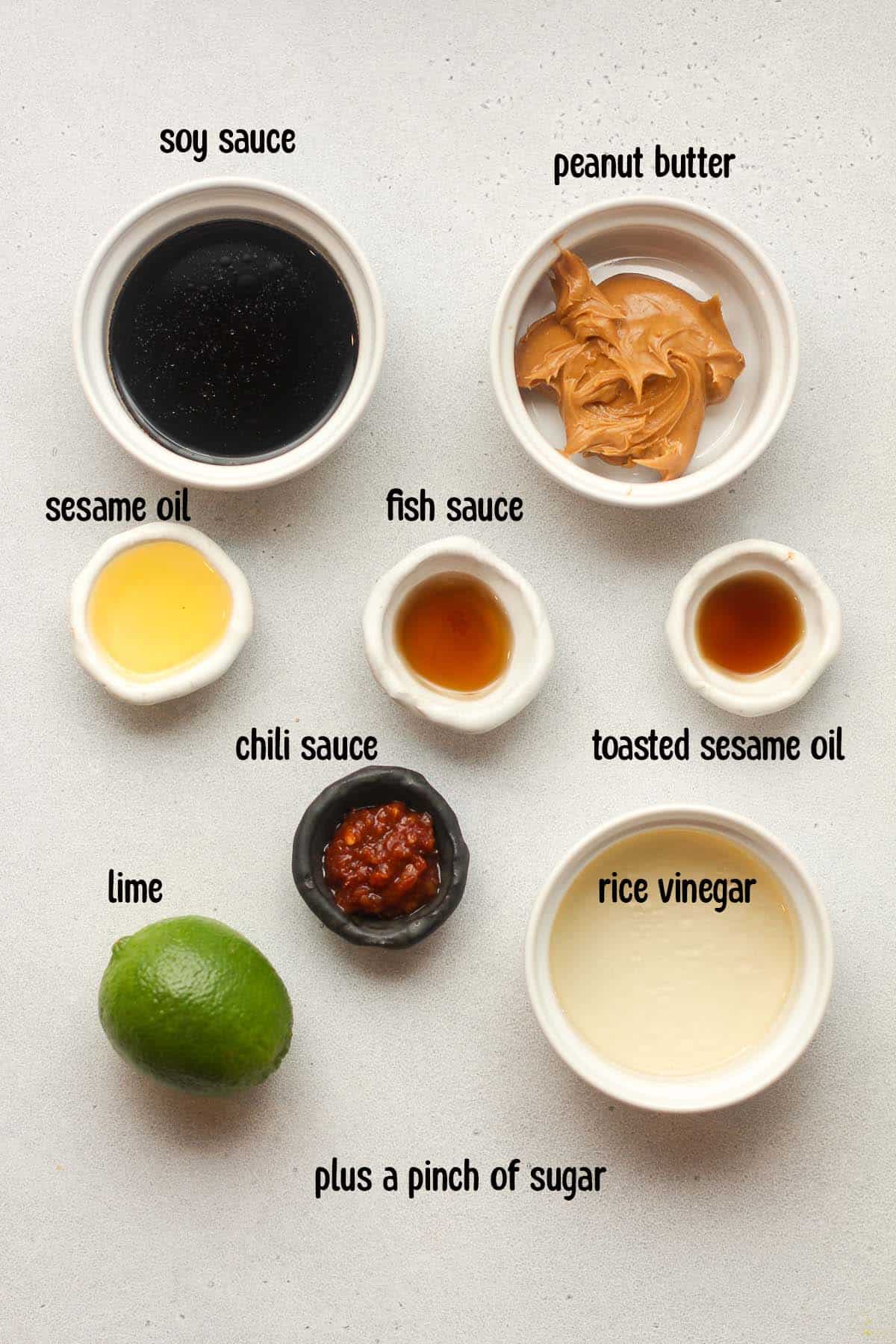 Labeled peanut sauce ingredients in small bowls.