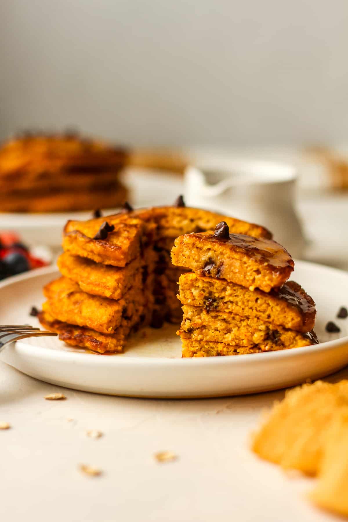 A plate of four pumpkin pancakes showing the insides with chocolate chips.
