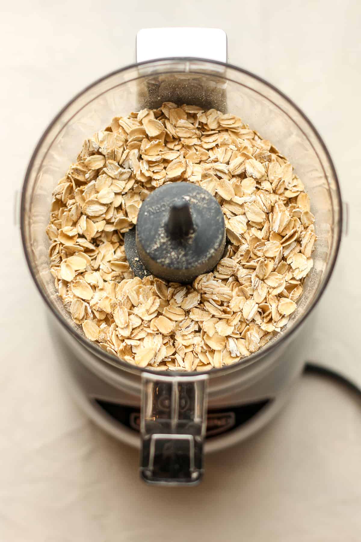 A food processor filled with old fashioned oatmeal.