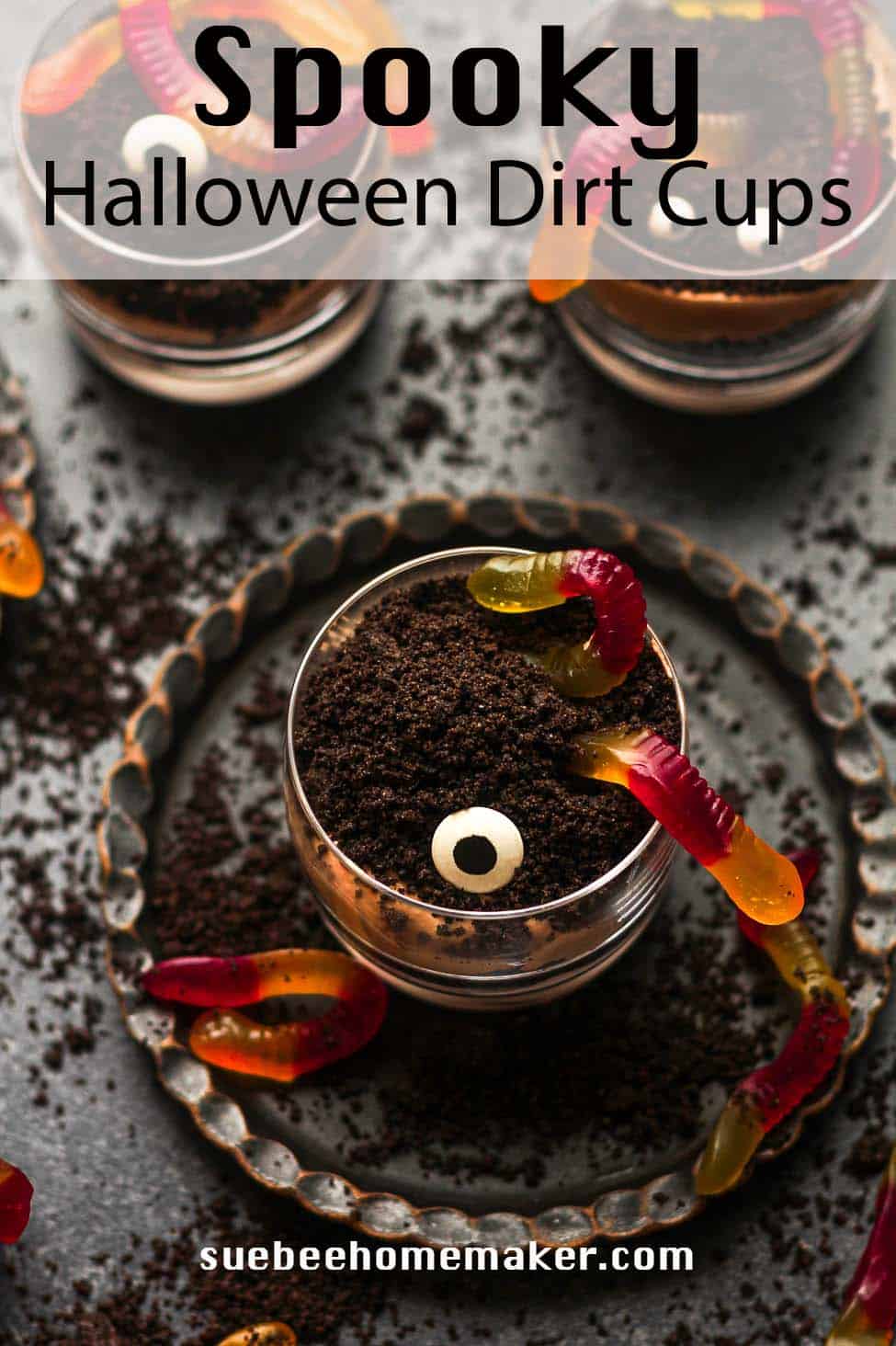 Overhead view of spooky Halloween dirt cups on a dark background.