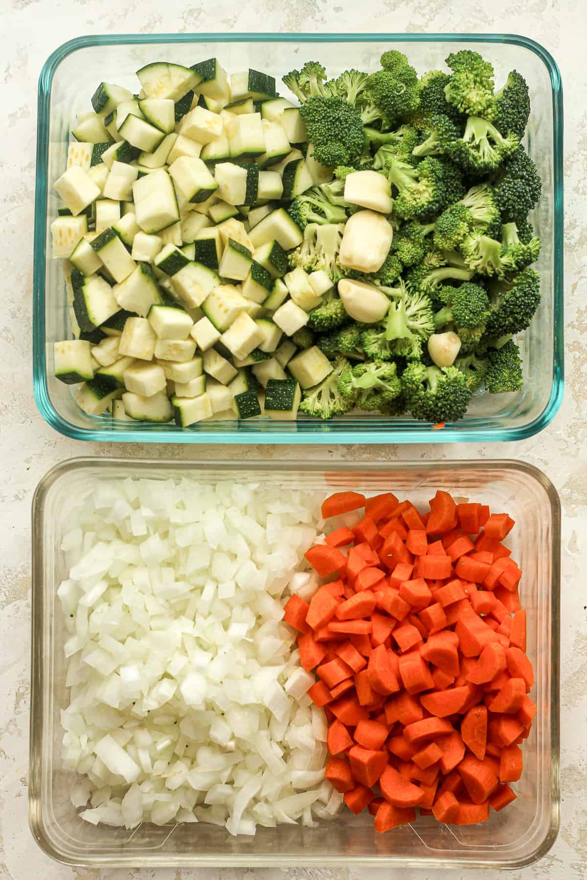 Two rectangular dishes with the chopped veggies.