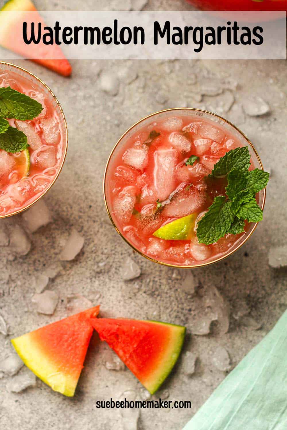 Two watermelon margaritas with mint leaves.