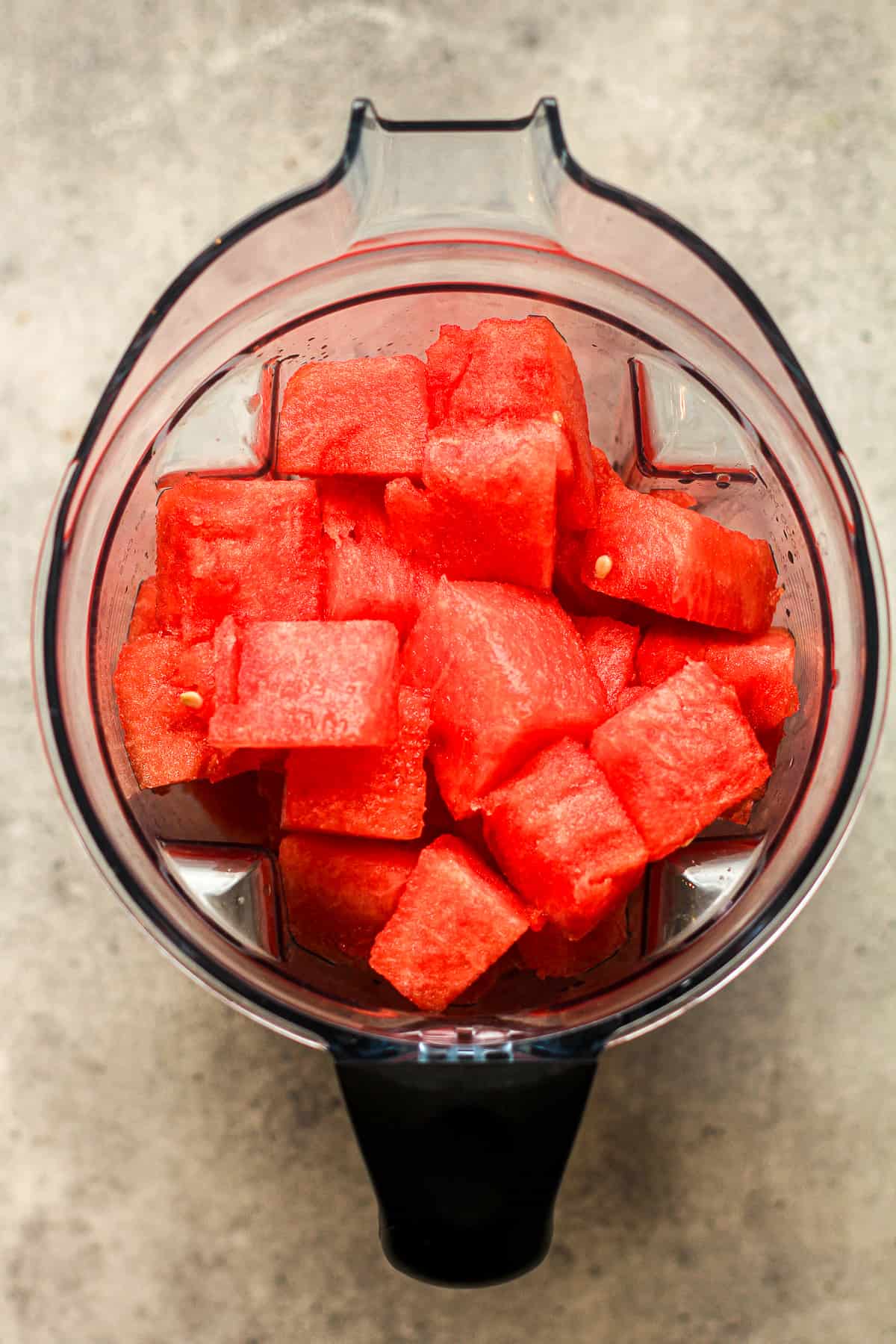A blender full of watermelon chunks.