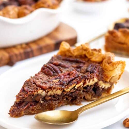 Side view of a slice of chocolate pecan pie.
