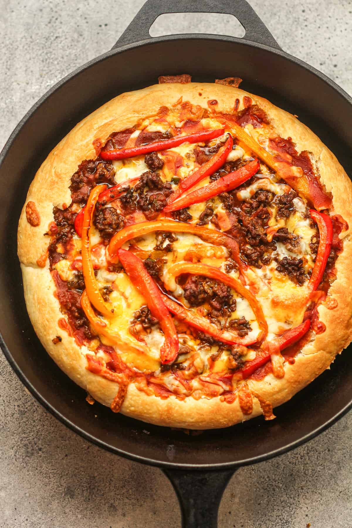 A skillet with the just baked Godfather's pizza before fresh toppings.