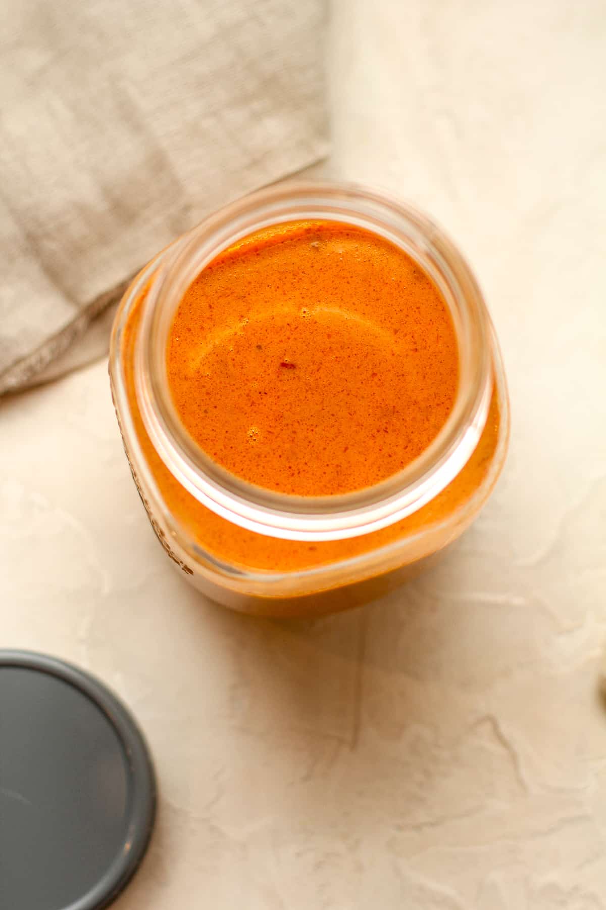Overhead view of a jar of curry sauce.