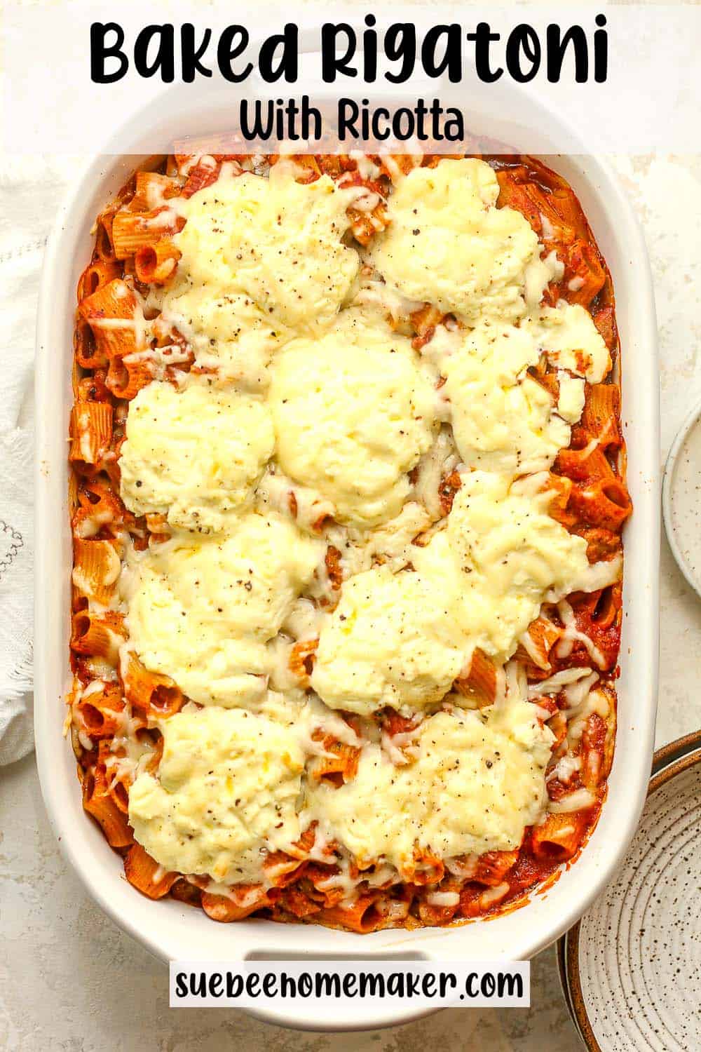 A large casserole pan of baked rigatoni with ricotta cheese.