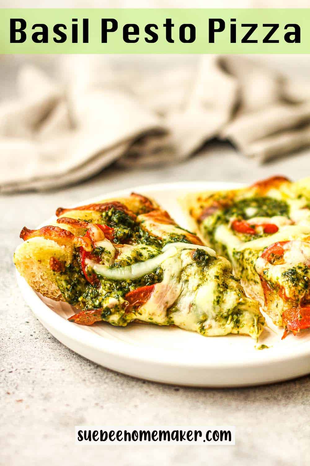 Side view of a plate of pesto pizza slices.