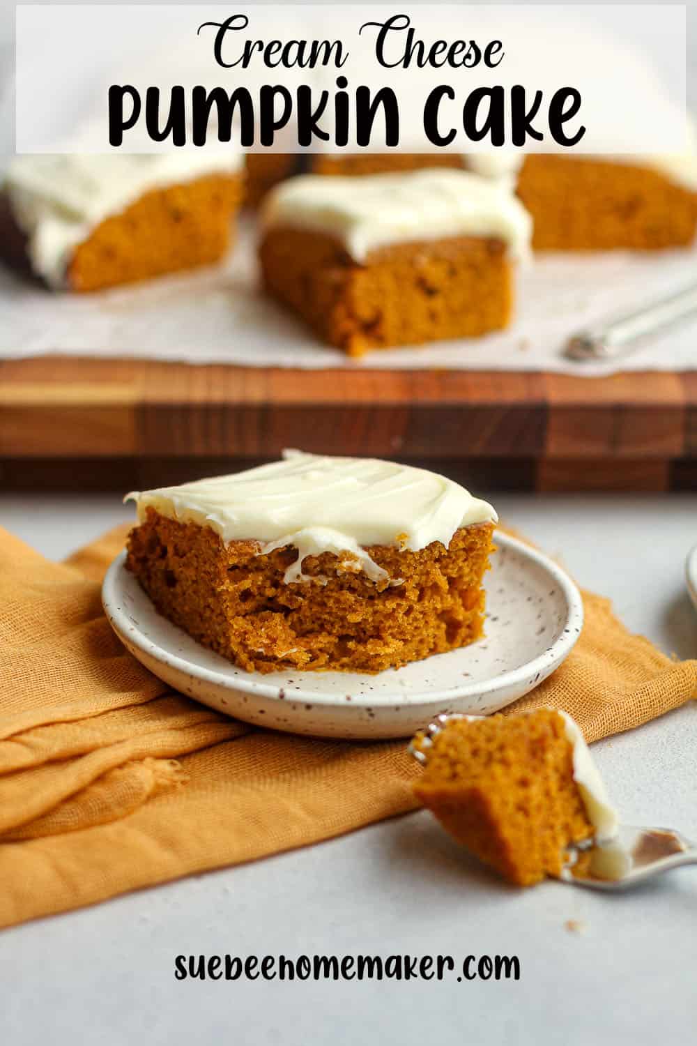 Side view of a slice of pumpkin cake with a bite out.