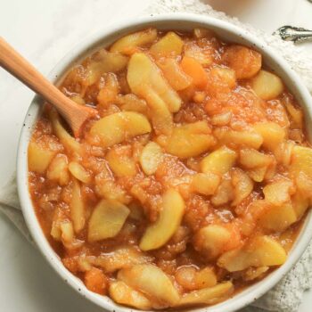 A closeup on a bowl of chunky applesauce.