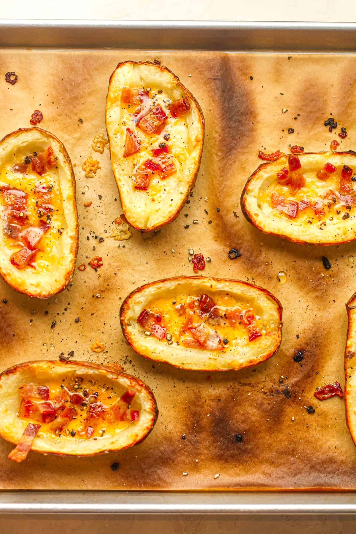 A pan with just broiled potato skins.