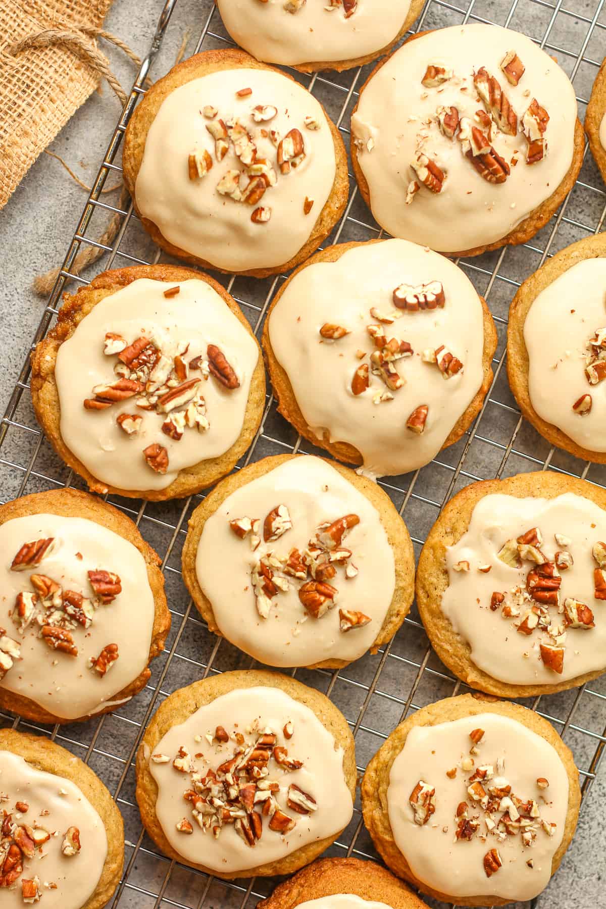 A cooling rack with iced maple cinnamon cookies.