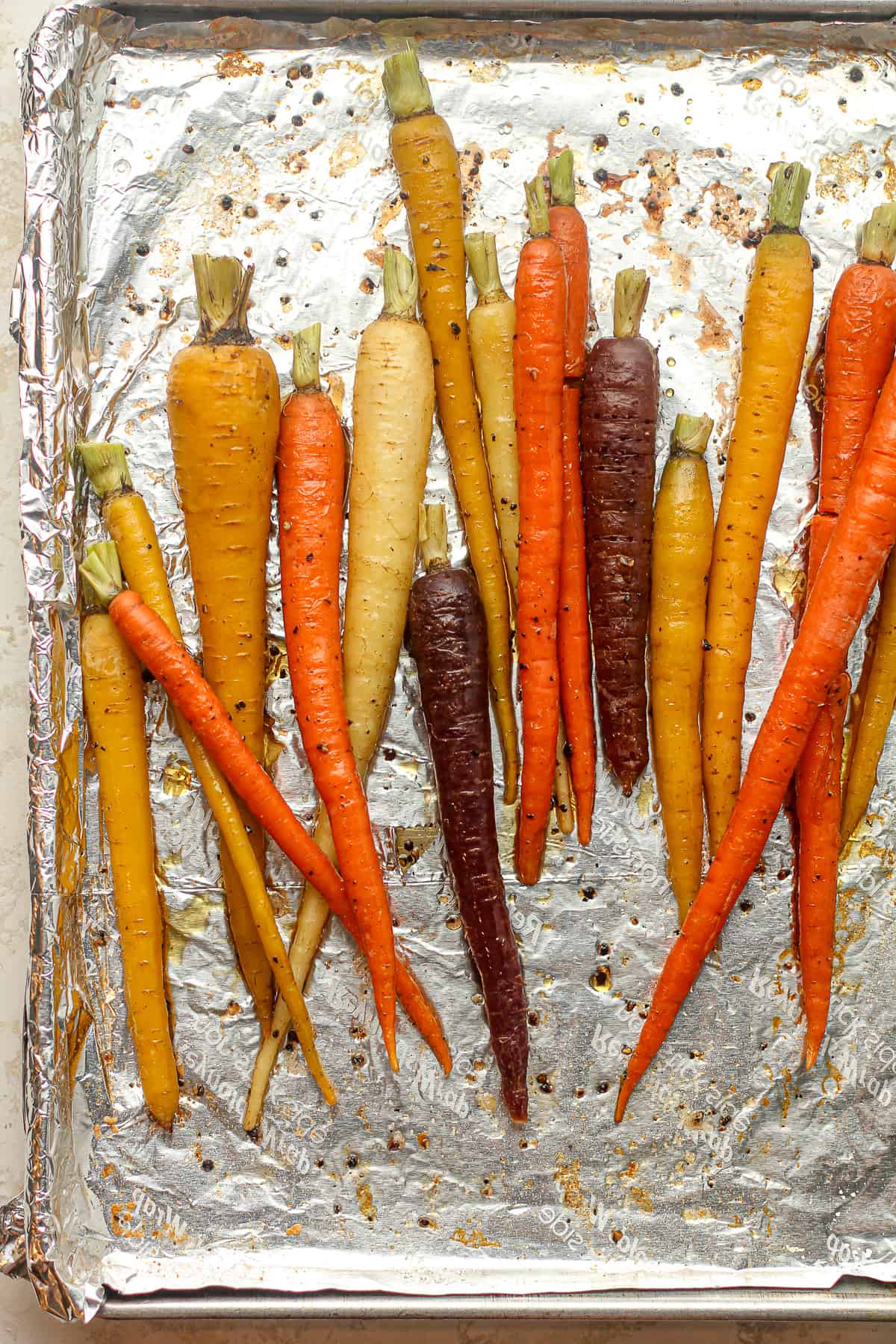 A pan lined with foil with the maple glazed carrots.