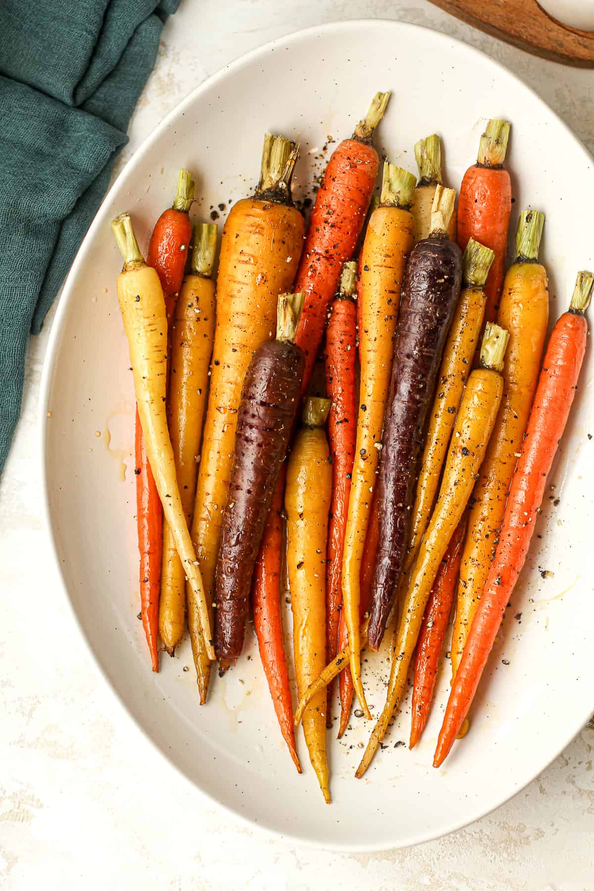 A serving dish with maple glazed roasted carrots.
