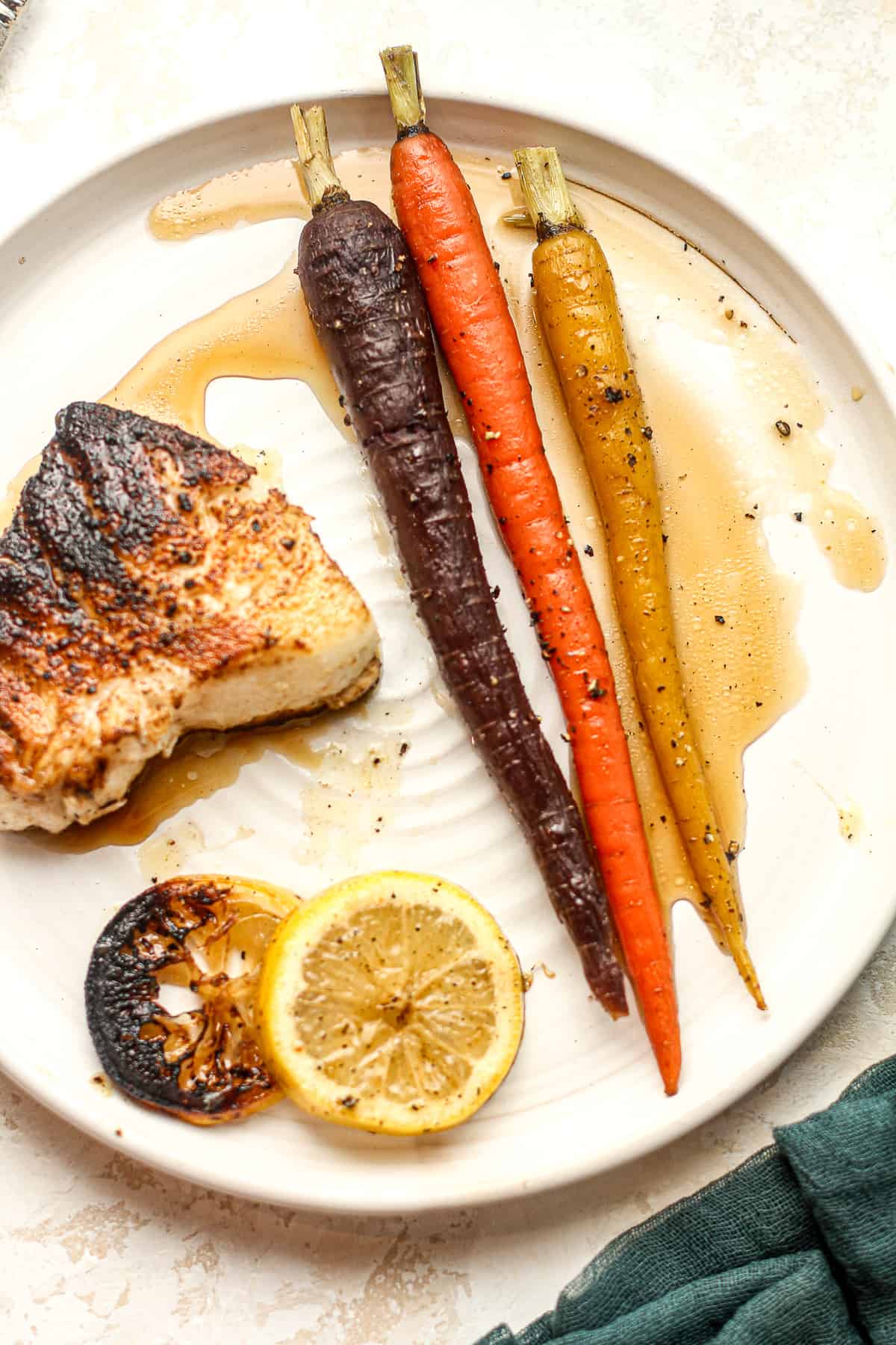 A plate of sea bass with roasted maple carrots.