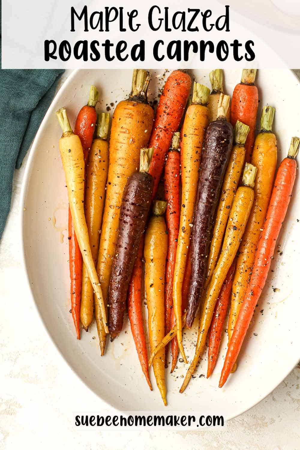 An oblong serving dish of maple glazed roasted carrots.