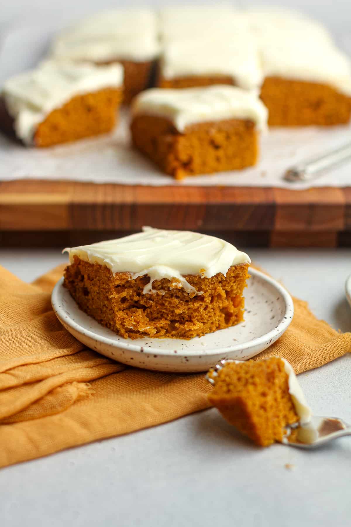 Side view of a piece of pumpkin cake with a bite out.