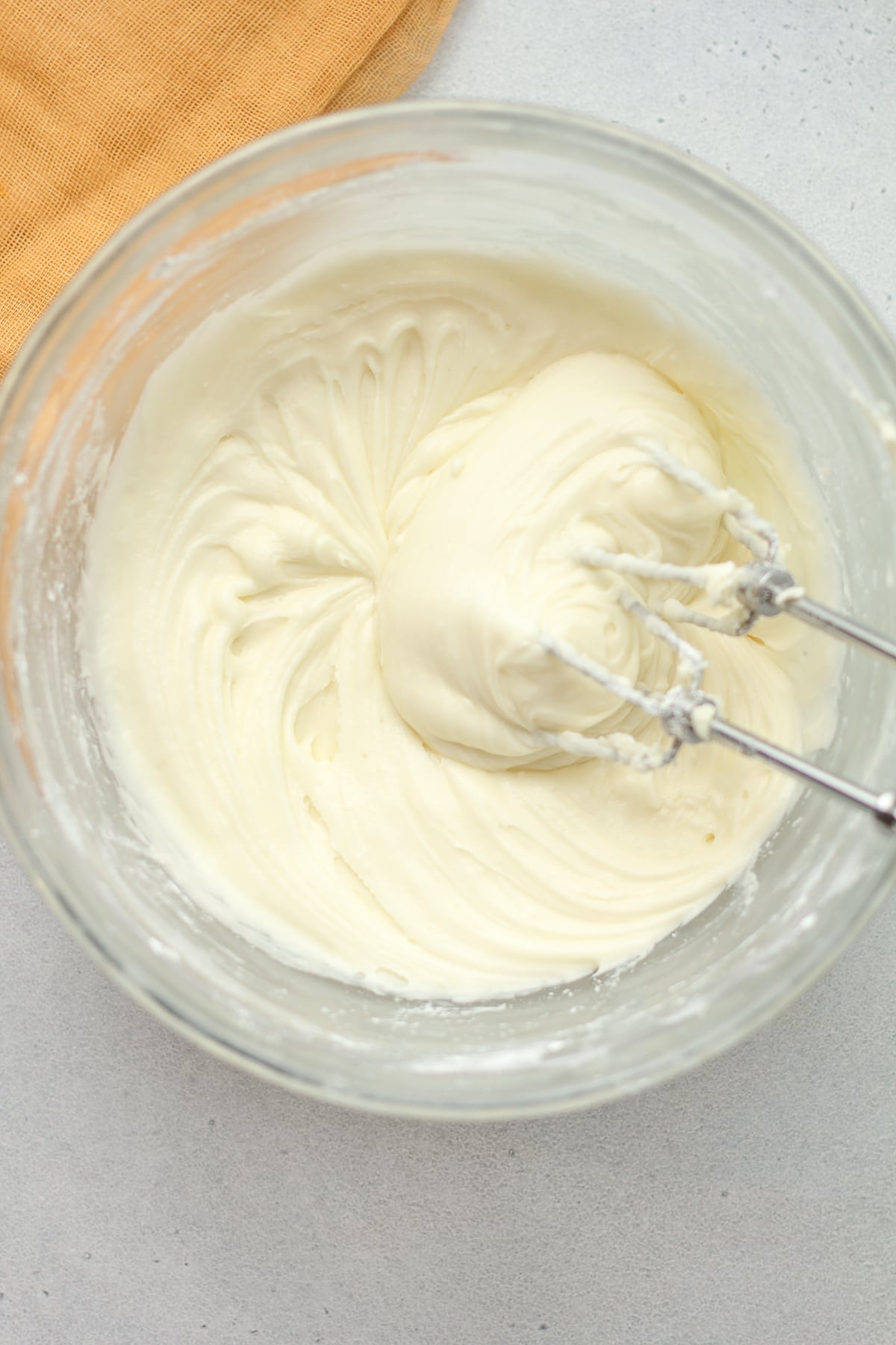 A bowl of whipped cream cheese frosting.