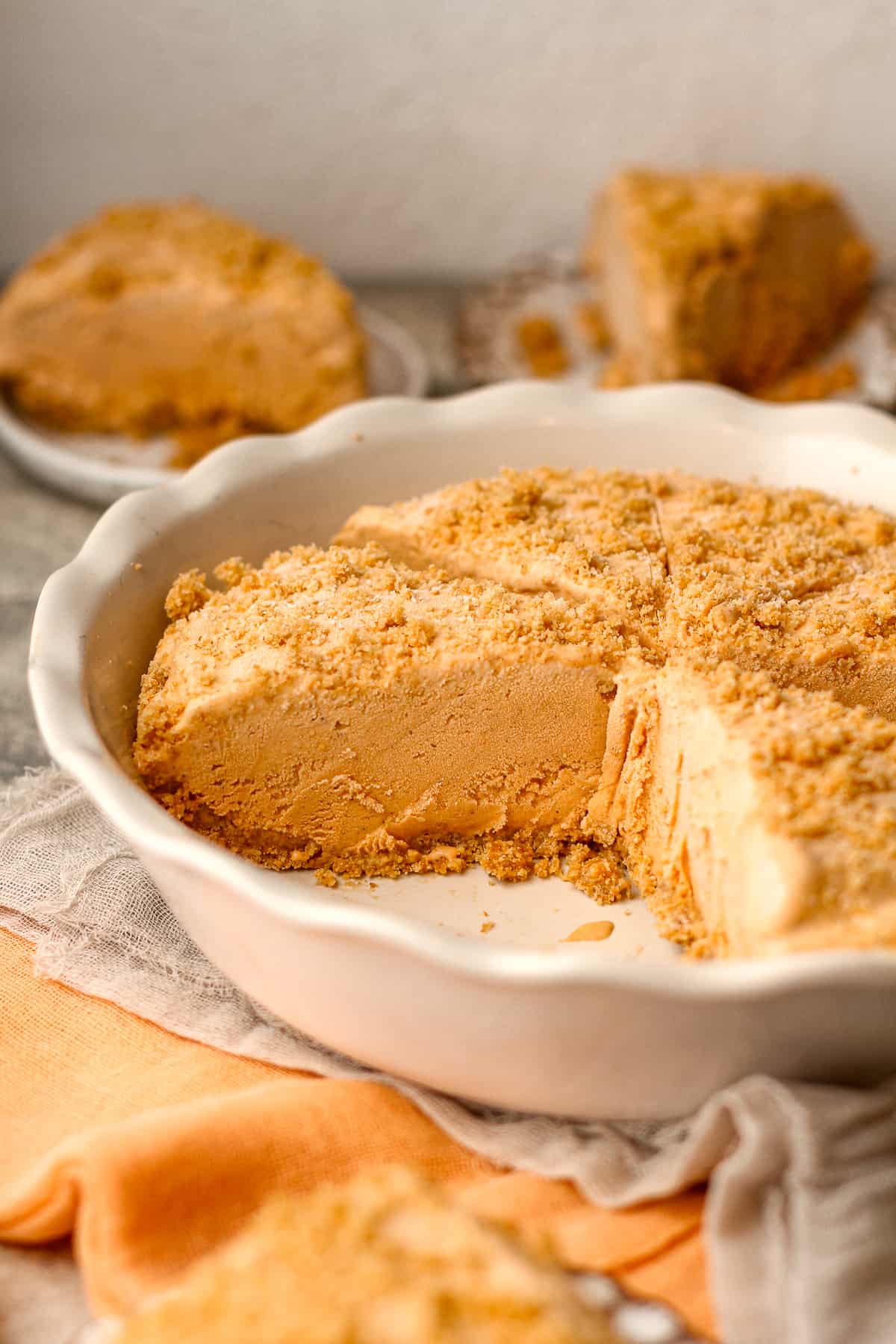 Side view of a pie pan of pumpkin pice cream pie.