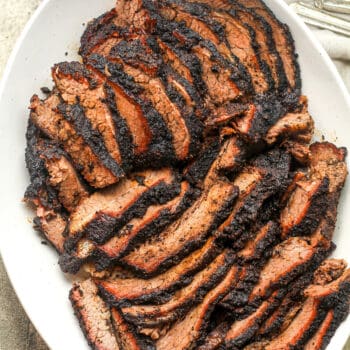 Closeup on a platter of smoked beef brisket.